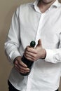 A Waiter in white shirt opens a Bottle of Champagne Royalty Free Stock Photo