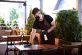 The waiter works in a restaurant in a medical mask, gloves during coronavirus pandemic Royalty Free Stock Photo