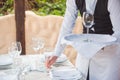 The waiter works in a restaurant on the summer terrace Royalty Free Stock Photo