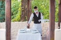 The waiter works in a restaurant on the summer terrace Royalty Free Stock Photo