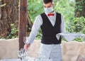 The waiter works in a restaurant on the summer terrace Royalty Free Stock Photo