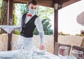 The waiter works in a restaurant on the summer terrace Royalty Free Stock Photo