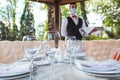 The waiter works in a restaurant on the summer terrace Royalty Free Stock Photo