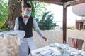 The waiter works in a restaurant on the summer terrace Royalty Free Stock Photo