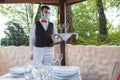 The waiter works in a restaurant on the summer terrace Royalty Free Stock Photo