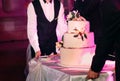 waiters carry three story wedding cake table Royalty Free Stock Photo