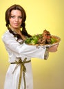 Waiters carrying plates with meat on yellow background Royalty Free Stock Photo
