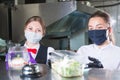 Waiters serve food container in restaurant