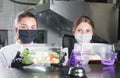 Waiters serve food container in restaurant