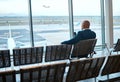 Waiting, airport and black man on a phone rest for travel, plane and air flight. Businessman, mobile connection and