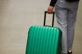 Waiting at the airport. The concept of summer vacation, a traveler with a suitcase in the waiting area of the airport terminal. Se Royalty Free Stock Photo