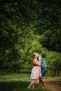 In waiting baby. happy family. pregnant woman with beloved husband embrace, barefoot on the grass. round belly. The sincere tender Royalty Free Stock Photo