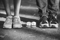 Waiting of baby. Little booties, sneakers near the feet of my father and mother. Pregnant woman, pregnancy, motherhood Royalty Free Stock Photo