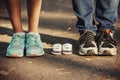 Waiting of baby. Little booties, sneakers near the feet of my father and mother. Pregnant woman, pregnancy, motherhood Royalty Free Stock Photo