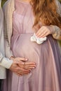 Waiting for baby, mammy`s and Dad`s hands on a belly. Royalty Free Stock Photo