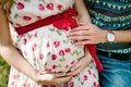 Waiting baby. pregnant woman with beloved husband sit on a bench. Husband hand embraces a round belly wife. Parenthood. pregnant Royalty Free Stock Photo