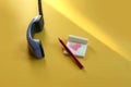 Waiting for a call from relatives: a notebook with a drawn heart, a pencil, a telephone receiver on a yellow background in the Royalty Free Stock Photo