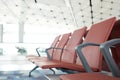 Waiting chairs of passengers in red airport. The background is the atmosphere in the airport. For passengers waiting to leave or m