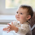 Waiting for food, baby todd is sitting at an empty table. A child in antici Royalty Free Stock Photo