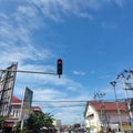 waiting for the green light on a street in Jambi Indonesia while looking at the blue sky