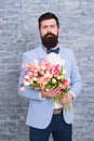 Waiting for his girlfriend. Romantic man with flowers. Romantic gift. Macho getting ready romantic date. Tulips for Royalty Free Stock Photo