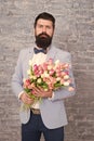 Waiting for his girlfriend. Romantic man with flowers. Romantic gift. Macho getting ready romantic date. Tulips for Royalty Free Stock Photo