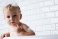 Waiting for mommy to wash me. Portrait of an adorable baby boy standing in the bath tub. Royalty Free Stock Photo