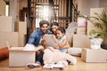 Waiting for the movers to arrive. Full length shot of an affectionate young family unpacking their boxes on moving day.