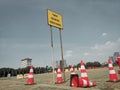 a waiting sign and messy traffic cones