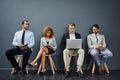 Waiting for their opportunity. Full length shot of a group of businesspeople waiting in line for a job interview. Royalty Free Stock Photo