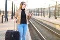 Waiting for train. Woman buying electronic ticket. Royalty Free Stock Photo