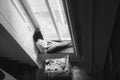 Waiting at window, girl, black and white