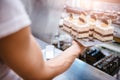 Waitress arranging cakes