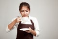 Waitress or barista in apron drinking coffee Royalty Free Stock Photo