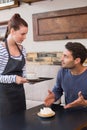 Waitress bringing man coffee and tart