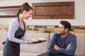 Waitress bringing man coffee and tart