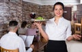 Waitress bringing order for guests in country cafe Royalty Free Stock Photo