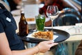 The waitress brings the order on a tray.