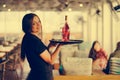 The waitress is carrying a bottle of wine Royalty Free Stock Photo