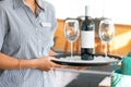 The waitress is carrying a bottle of wine Royalty Free Stock Photo