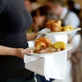 Waitress carrying two plates with meat dish Royalty Free Stock Photo