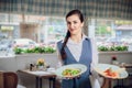 Waitress is carrying two plates with restautant delicious dishes Royalty Free Stock Photo