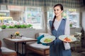 Waitress is carrying two plates with restautant delicious dishes Royalty Free Stock Photo