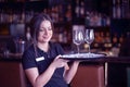 The waitress is carrying a wine glasses Royalty Free Stock Photo