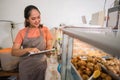 waitress checking preparations at a traditional food stall display