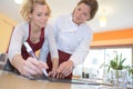 waitress and chef writing specials board Royalty Free Stock Photo