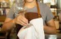 Waitress cleaning glasses in cafe shop