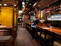 A waitress cleans the empty tables at The Public Izakaya Japanese restaurant in Tanjong Pagar, Singapore