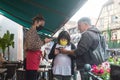 waitress controlling the sanitary pass at the restaurant terrace in the street