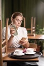 Waitress counting salary or tips in dollars while sitting in a cafe, give the waiter a tip, counting money in a cafe. Royalty Free Stock Photo